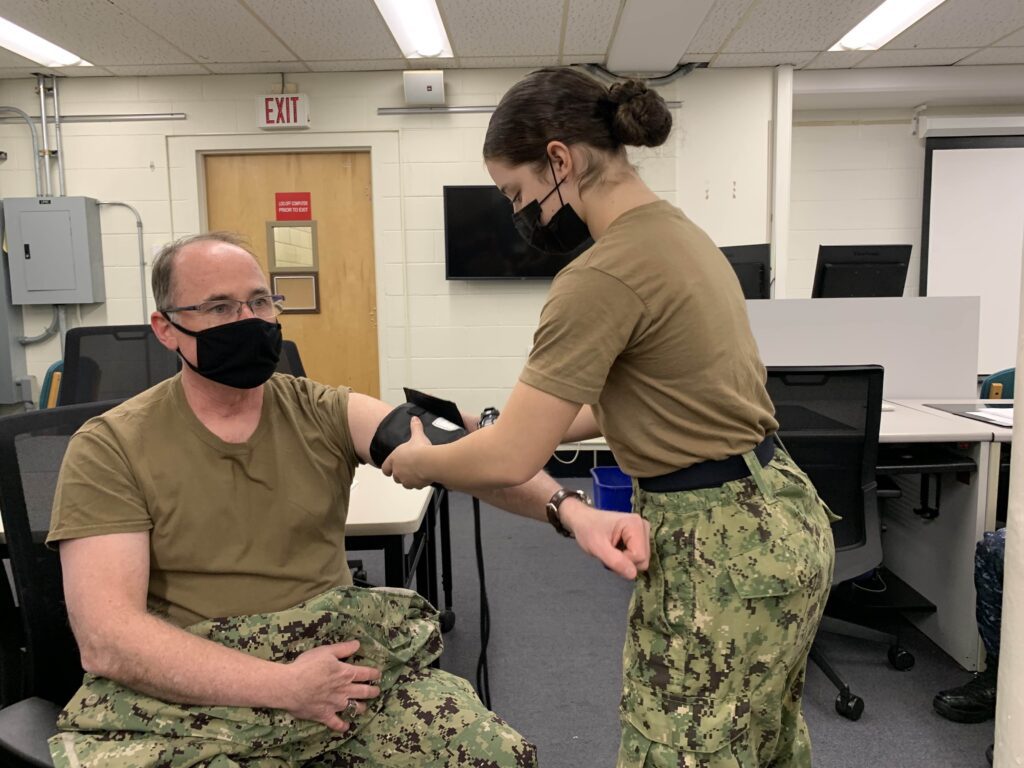 Cadet taking the Master Chief's blood pressure